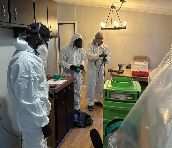 SERVPRO team in PPE working to clean up mold exposure from water damage